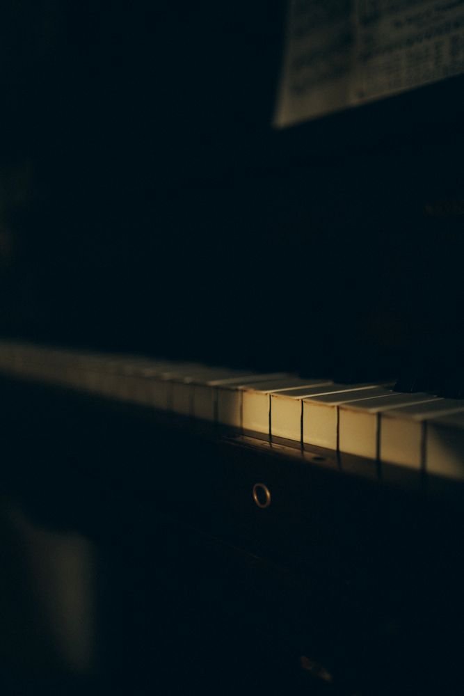 Warm light falling across piano keys